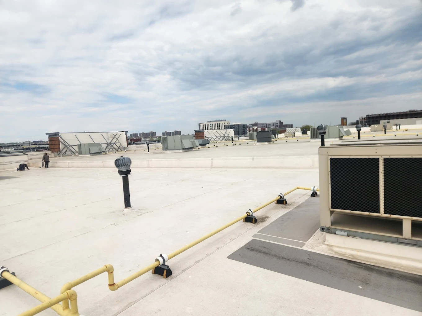 All-Star Roofing Inc. crew installing commercial flat roof on a Copiague, NY industrial building — Suffolk County roofing contractor from Amity Harbor